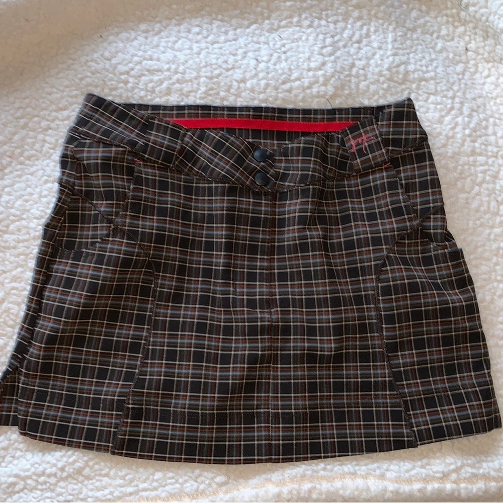 Small plaid skirt from Zoic with brown, blue and orange stripes.